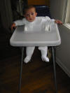 Alex gives his new high chair a tentative 'okay'